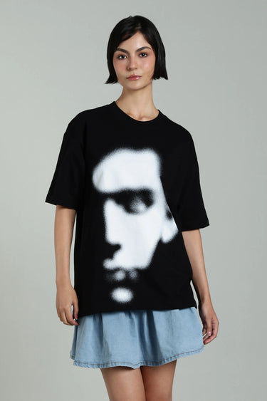 Model wearing oversized black abstract face t-shirt, featuring glitch art design, capturing overthinking and mental noise.