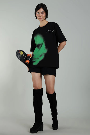 front view of a woman wearing green abstract face t-shirt