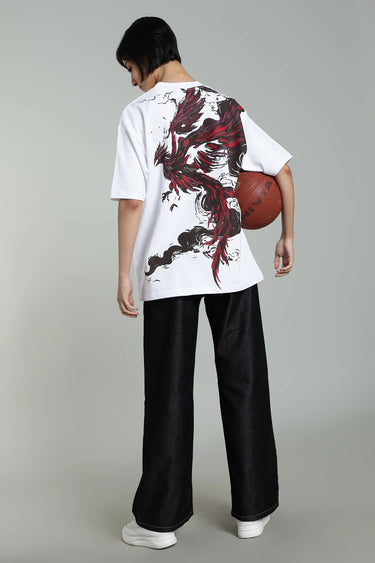 Backview of a a woman wearing the oversized, unisex white phoenix t-shirt, holding a basketball against a plain background
