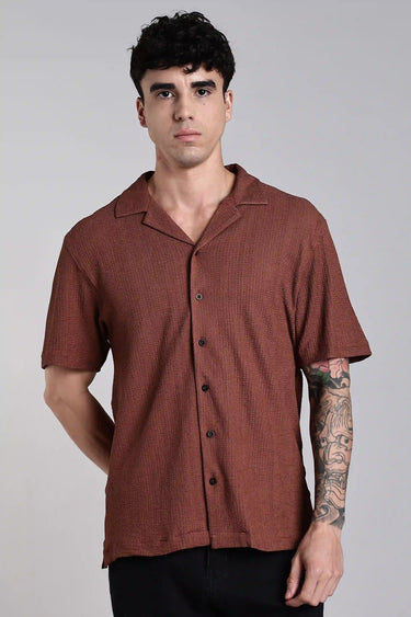 front shot a man wearing a brown textured shirt