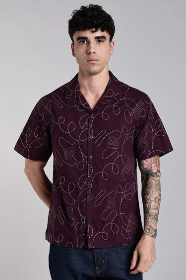 front view of man wearing purple embroidery shirt