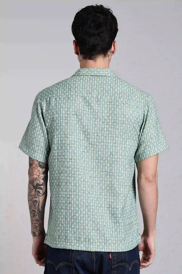 a man wearing sage green textured shirt - back view