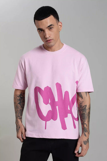 A man wearing the pink chaotic unisex oversized t-shirt