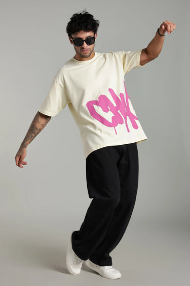 a man wearing biege chaotic oversized t-shirt