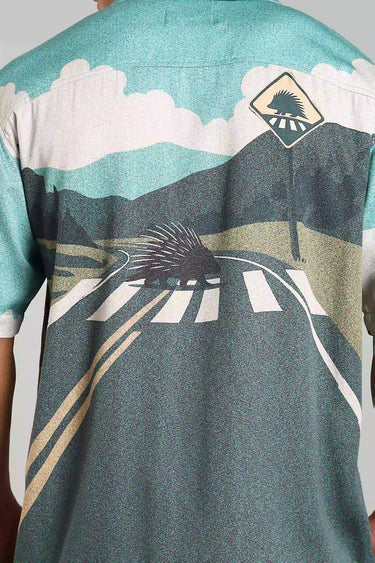 Back view of BON VOYAGE SHIRT featuring a scenic road design and vintage car, embodying wanderlust and adventure.