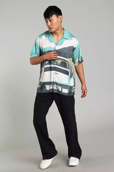 Male model wearing Bon Voyage shirt with vintage car print, embodying wanderlust and road trip vibes.