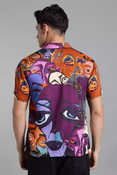 BACKVIEW of a man wearing a colorful, abstract-patterned shirt on a gray background