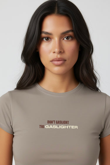 Woman wearing a dark beige crop top with text on a white background