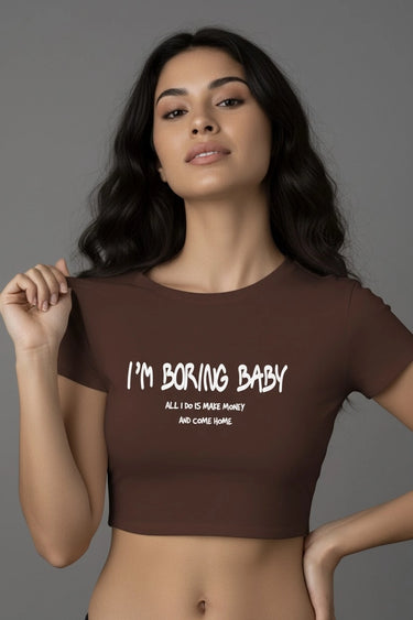 Brown fitted graphic crop top with “I’m Boring Baby” white text on front.