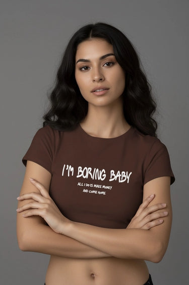 Brown fitted graphic crop top with "I’m Boring Baby" white text and short sleeves.
