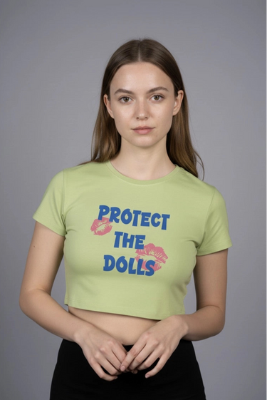Person wearing a green graphic crop top with text on a gray background