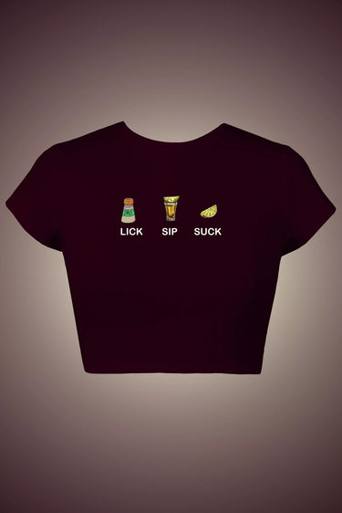 Maroon graphic crop top with text 'LICK SIP SUCK' and graphics on a gray background