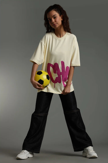 a woman wearing biege chaotic oversized t-shirt
