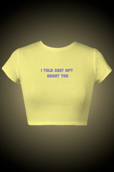Yellow graphic crop top with text on a dark background