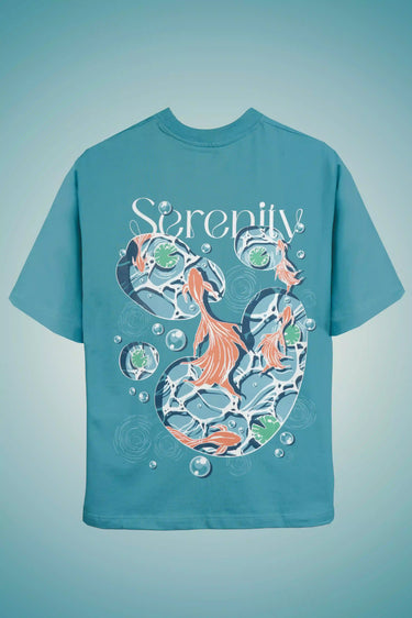 Unisex Oversized Teal t-shirt with fish design and 'Serenity' text on a light blue background