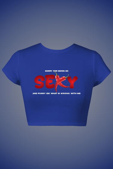 Blue graphic crop top with "Sorry for being so SEXY" red and white text design.