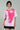 front profile of a woman wearing oversized pink abstract face t-shirt.