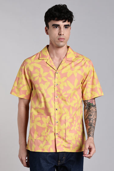 front view of a man wearing red and yellow floral print shirt 