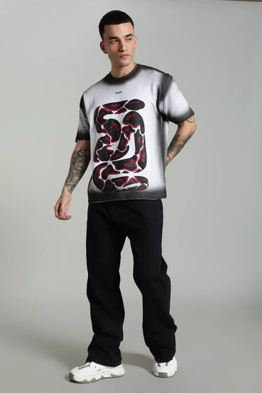 Man wearing a unisex oversized graphic t-shirt with a snake design on a plain background
