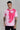 A man wearing a pink oversized abstract face t-shirt 