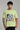 Man wearing the LIGHT GREEN DEAD END OVERSIZED T-SHIRT FOR MEN AND WOMEN with a graphic design on a gray background