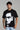 Black oversized t-shirt featuring abstract white face design, capturing glitchy expression of mental noise.