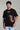 a man wearing the black centipede oversized t-shirt - front view