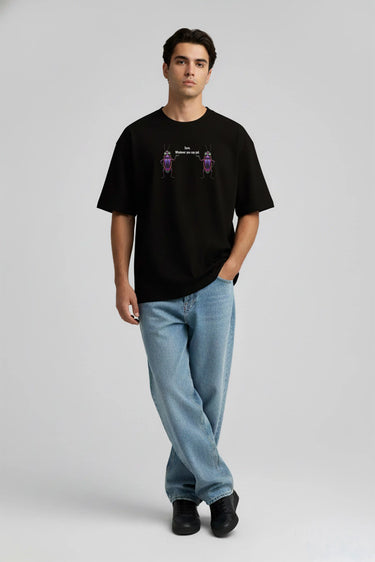 Black oversized graphic t-shirt with purple and white design, worn with light blue jeans.