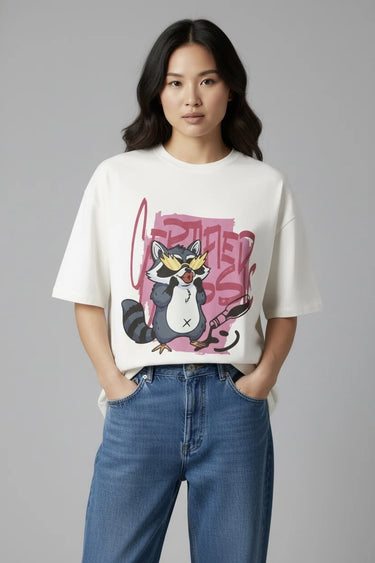 Person wearing a half white unisex oversized t-shirt with a graphic design and blue jeans on a gray background