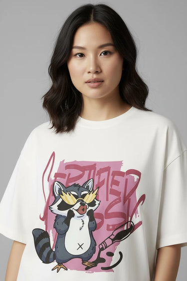 Person wearing a half white unisex oversized t-shirt with a cartoon raccoon design on a gray background