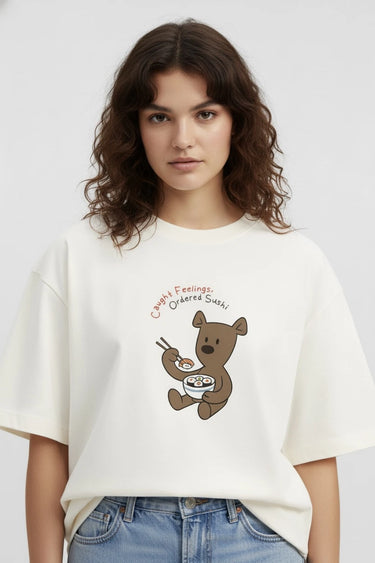 Person wearing a half-white unisex oversized t-shirt with a bear graphic and text on a plain background
