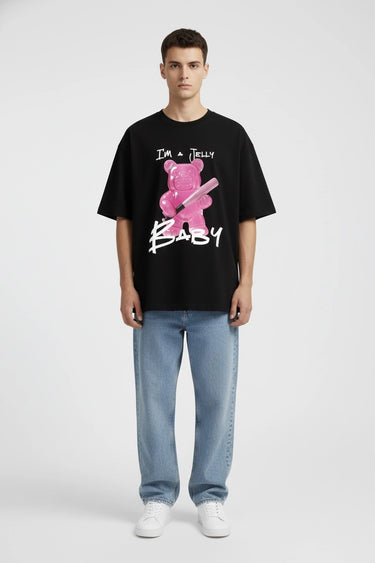 Black oversized graphic t-shirt with pink jelly baby print and white text, paired with light blue jeans.