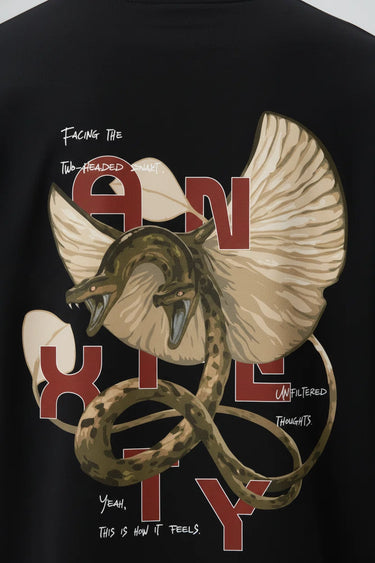 Black oversized graphic t-shirt with large bird and snake illustration and bold text design on the back.