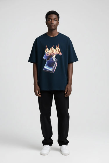 Navy oversized graphic t-shirt with fiery lighter design, paired with black pants and white sneakers.