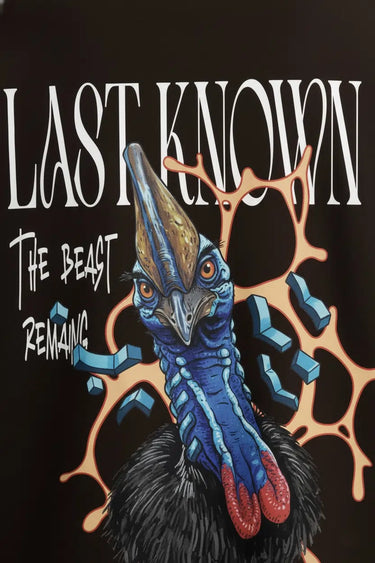 Black oversized graphic t-shirt with colorful mandrill face and "Last Known The Beast Remains" text design.