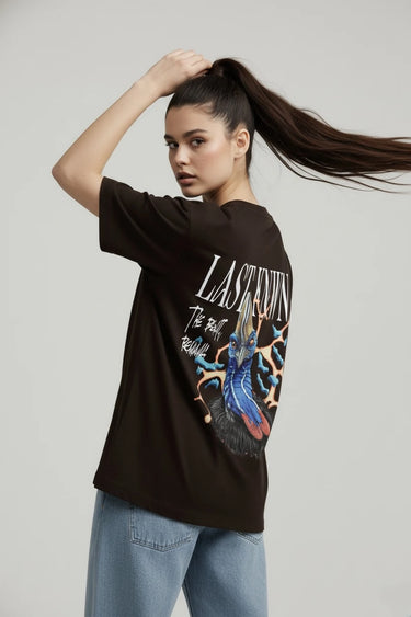 Black oversized graphic t-shirt with colorful Last Known design on back, worn with light blue jeans.