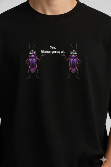Black oversized graphic t-shirt with colorful beetle illustrations and text "Sorry, whatever you say" on chest.