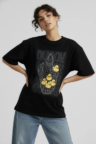 a woman wearing a black oversized graphic t-shirt with duck dolls on it. 