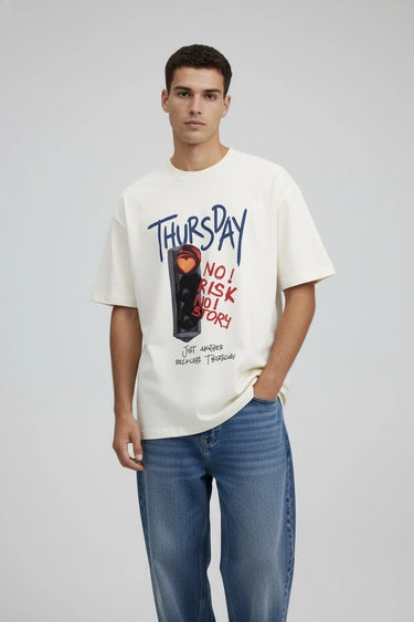 A person wearing the half white oversized graphic tee by LYVN featuring a traffic light and Thursday.