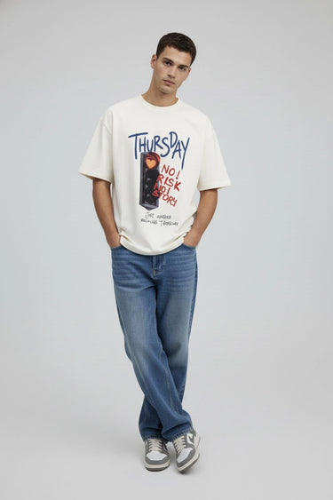 a man wearing the thursday half white oversized graphic t-shirt by LYVN