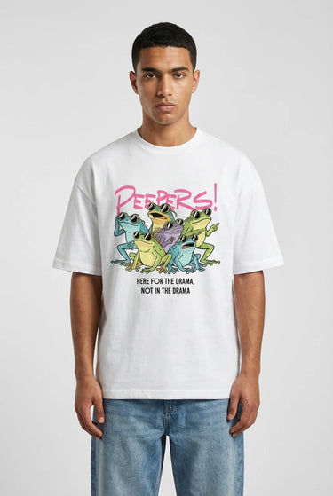 White oversized graphic t-shirt with colorful cartoon insect design and "Peepers!" text, worn with blue jeans.
