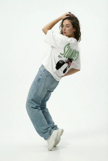a woman wearing the white lazy  oversized graphic t-shirt 