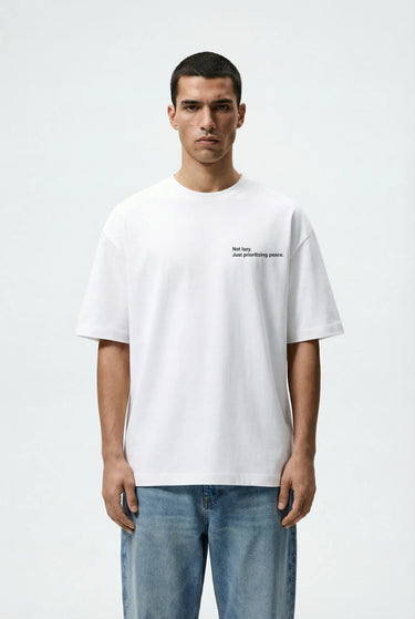 A man wearing the lazy white oversized graphic t-shirt