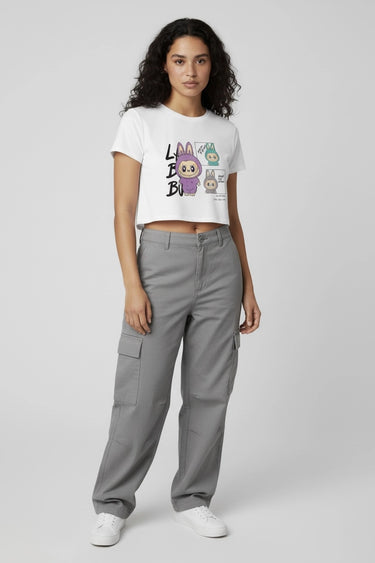 A woman posing with a white monster graphic crop top 