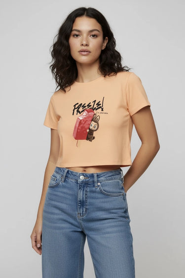 Peach graphic crop top with monster print and "Freeze" text on front. - LYVN