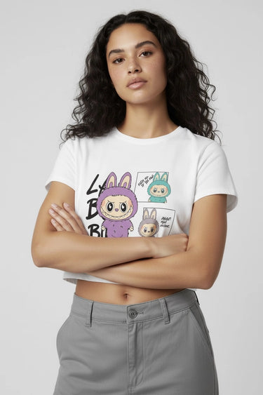 A woman wearing a white graphic monster crop top 