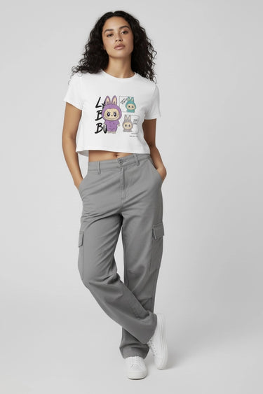 A model wearing the white monster doll crop top with grey cargo pants 