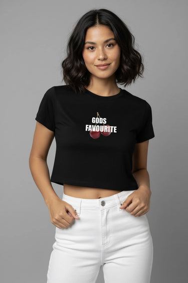 Woman wearing a black graphic crop top with text and graphics on a gray background