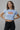 Light blue fitted graphic crop top with I Cannot Adult Today text in bold colorful fonts.