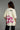 backview of a woman wearing biege chaotic oversized t-shirt